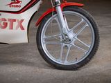 a red and white motorcycle parked in a garage