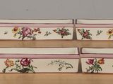 a set of three rectangular trays with floral designs on them