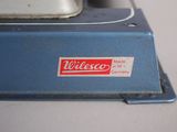 a close up of a blue and white machine on a table