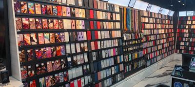 a wall of cell phones on display in a store