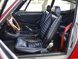 a red car with black leather seats and a steering wheel