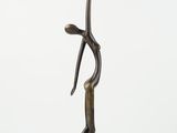 bronze statue of a man holding a branch on a white background