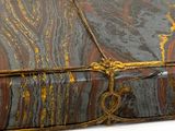 an old book with gold and black marble on it