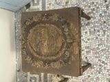 an old book on a stand on a mosaic floor