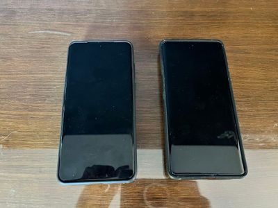 two iphones sitting side by side on a wooden table