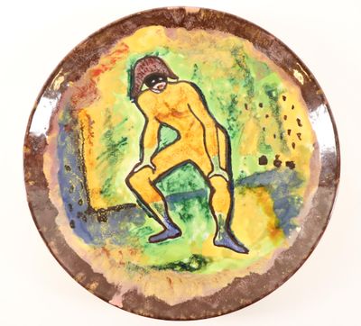 a plate with a painting of a man on it