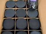 a cardboard box filled with many black jars