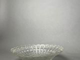 an image of a clear glass bowl on a gray surface