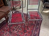 three chairs and a rug in a room with a red carpet