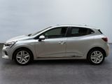 the silver car is parked on the concrete floor in the room