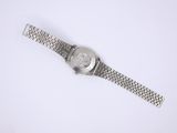 a close up of a wrist watch on a white surface