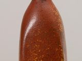 a brown vase sitting on top of a wooden table