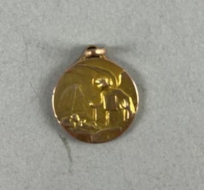 a gold medal with a picture of a man and a woman on it