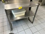 a stainless steel table with a plastic container on top of it
