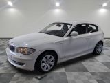 a picture of a white car parked in a garage