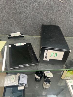several electronic devices are on a glass shelf in a room