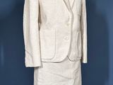 an image of a white suit and skirt on a mannequin stand