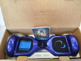 a purple hoveboard in a cardboard box with a video game on it