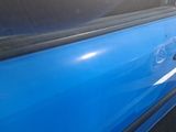 a close up of a blue car with a broken door handle