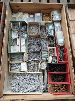 a box full of assorted screws and nails in it