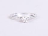a white gold engagement ring with a round brilliant cut diamond