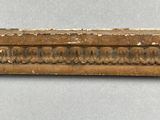a close up of a piece of wood with a decorative design on it