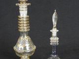 two glass candlesticks and a glass candle holder on a black background