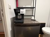 a small refrigerator in the corner of a small room
