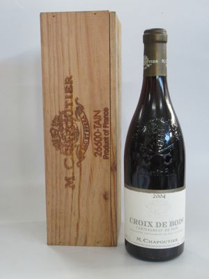 a bottle of wine sitting next to a wooden box