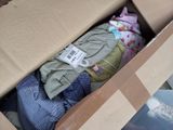 a box full of clothes that is sitting on the floor