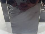 two boxes of black diamond perfume sitting on top of a white table