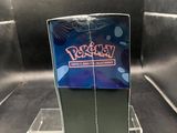 someone is holding a pokemon trading card in front of a display case