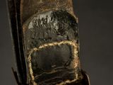 a close up of a cell phone with a leather case