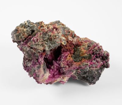 a close up of a piece of rock with a pink substance on it