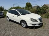 a picture of a white car parked in a gravel lot