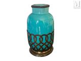 a blue glass vase with a decorative design on it