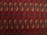 an image of a red and black rug with a pattern on it