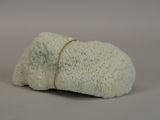 a white rock with a rope on it on a gray surface