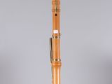 an orange and black musical instrument sitting on top of a clear stand