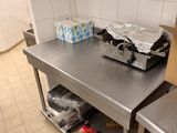 a metal work table with a bunch of items on it