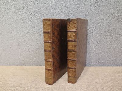 two old books that are sitting on a table