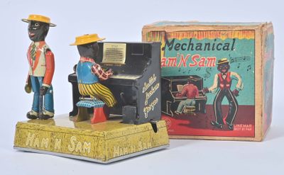 toy figurine of a man and a woman playing a piano