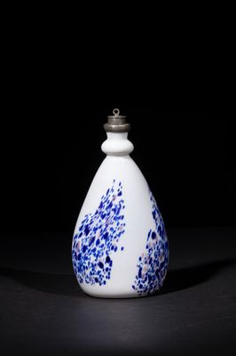 an image of a white and blue vase sitting on top of a table