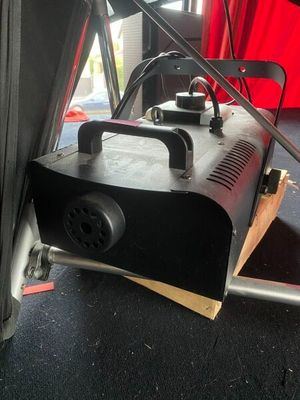 a black smoke machine that is sitting on the floor