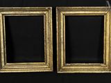 two antique gold picture frames on a black background