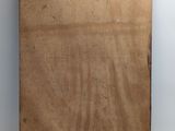 an old wooden cutting board with a piece of wood sticking out of it