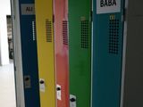 several colorful lockers are lined up in a row in a hallway