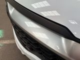 a close up of a car ' s front grill with a lot of stickers on it