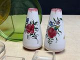 two salt and pepper shakers sitting on a table