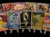 a lot of pokemon cards on display on a black background